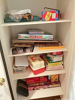 Shelf with multiple board games and puzzle boxes