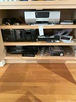 Overview of shelves showing multiple Sony and Elite components and cables