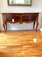 Front view of mahogany console table showing full structure, drawers, legs