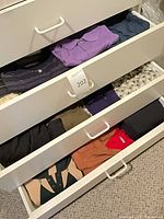 Top drawer showing multiple folded polo and button-front shirts