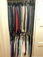 Closet view showing upper row of jackets and lower row of shirts