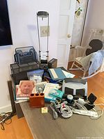 Overall view showing lamps, organizers, hole punch, cables, books, speaker