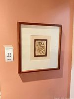 Vertical framed artwork on wall