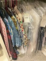 Assortment of shirts on hangers showing variety of patterns and colours
