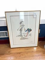 Framed print leaning against wall showing full artwork and frame