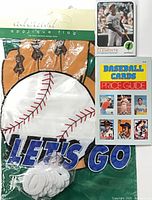 Packaged adorned applique flag with baseball graphic, Roberto Clemente card, price guide booklet