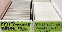 Two storage boxes with handwritten labels identifying 1991 Parkhurst NHL full set and 1991-92 U.D. NHL complete set (1-500)