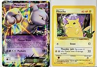 Mewtwo EX and Pikachu oversized cards side by side
