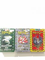 Front view of three sealed MetaZoo Release Event Boxes in green, gray, yellow
