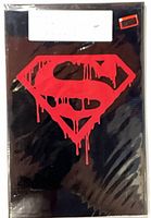 Front view of sealed comic showing red dripping Superman emblem on black polybag