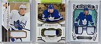 Group shot of all three Travis Dermott rookie patch cards in holders