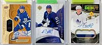 Group image showing all three Travis Dermott autographed, numbered cards