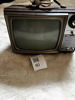 Front view showing screen, speaker grille, channel dial, lot tag