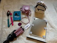 Group layout showing all items: hair waver, vanity mirror, Instax case, backpack, two selfie sticks, Digital Basics box