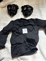 shirt laid flat showing padding and two skull masks