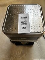 Top view showing stainless perforated lid and MaxSold lot sticker