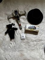 Overview of four items: boxed Corgi tanker, Star Wars X-wing, plush bear, plastic hat