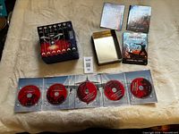 Overview of both DVD sets laid out with discs and cases visible