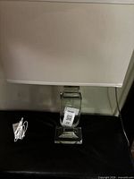 Front view of lamp showing shade and glass base