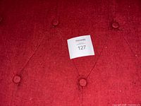 Close-up of red button-tufted upholstery fabric