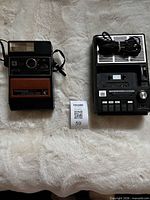 Front view of both items: Kodak Colorburst 300 camera and cassette radio recorder