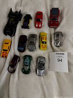 Overview of all 12 die-cast cars laid out on white surface