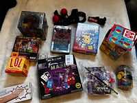 Full lot overview showing all boxed games, puzzle, magic kit, Boxbollen headband, Top Top toys and jar of chips