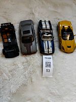 All four Maisto die-cast cars aligned on surface