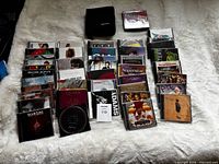 Wide shot of all jewel case CDs laid out with zip pouch and Eagles Live CD