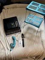 Group shot of all items: shelf, desk organizer, calculator, handset, selfie stick