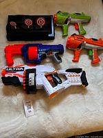 All four blasters and target stand displayed