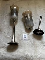Both hurricane candle holders, one assembled, one disassembled