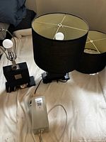 Overview showing both black lamps with shades and small white lamp