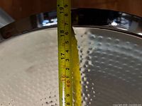 Measuring tape inside bowl showing approx 19 in diameter