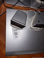 Top view of DVD receiver with two satellite speakers and wires