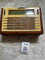 Front view showing cream panel, grille, and dial