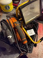 Ridgid belt sander and work light stacked together showing overall lot contents