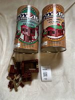 Two Roy Toy cans with loose wooden pieces and partial build visible