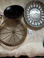 Top view of all three pieces: wire bowl, wooden bowl, metal tray