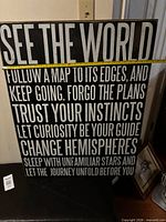 Full view of wall art sign with tape for scale