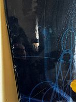 Close-up of topsheet showing scratches and blue graphics