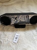 Front view of Sony docking speaker showing graphic grille and dock