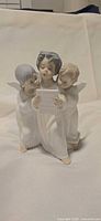 Front view of three-angel choir figurine