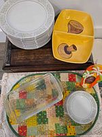 Stack of Taheri China plates, yellow divided dish, two glass loaf pans