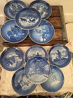 Group shot showing all ten blue & white Royal Copenhagen Christmas plates with wire hangers