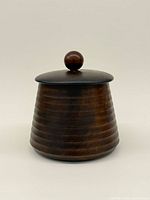 Front view of walnut lidded jar