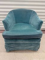 Front view of blue velvet tub armchair