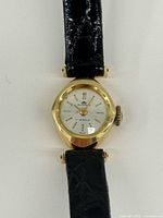 Front view showing dial, case shape and strap