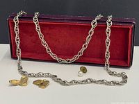 All three jewelry pieces together: silver-tone necklace, gold-tone cufflinks pair, faux pearl pin