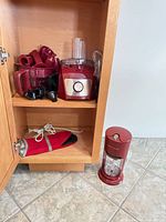 overview of food processor base, attachments and separate grinder in cabinet